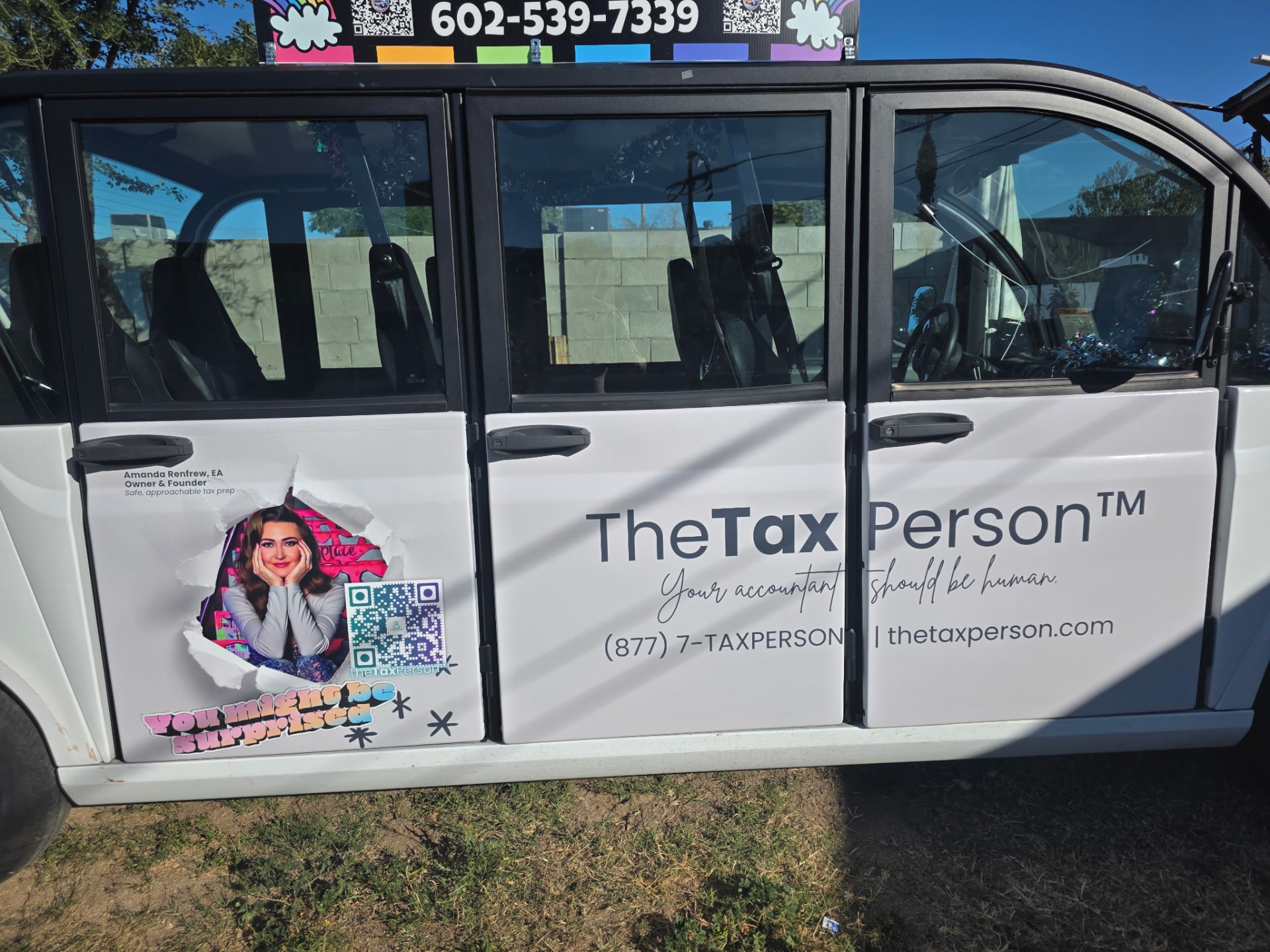 The TheTaxPerson shuttle, wrapped with the logo and slogan — your accountant should be human